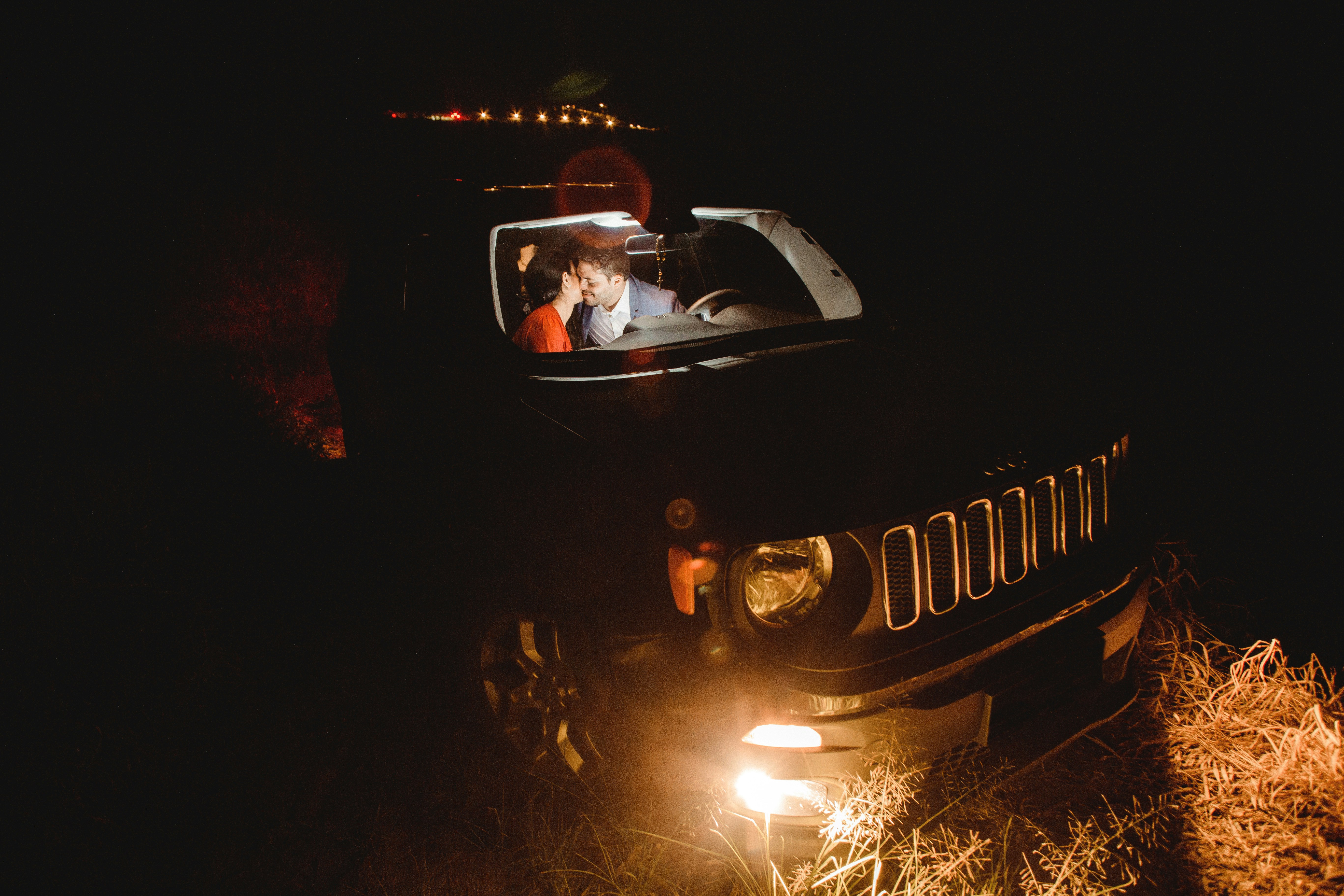 man in black jacket driving black car