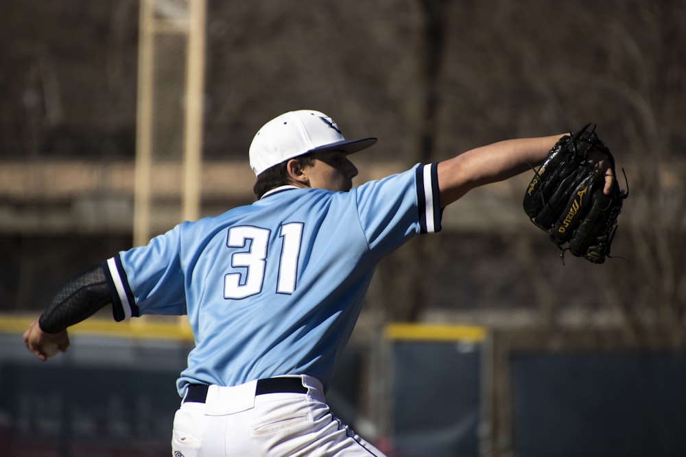 man in blue and white jersey shirt wearing black baseball helmet