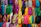 Close-up of elegant unstitched fabric rolls in vibrant colors displayed neatly.