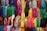A vibrant display of colorful fabrics and clothing rolls in a wholesale fashion warehouse.