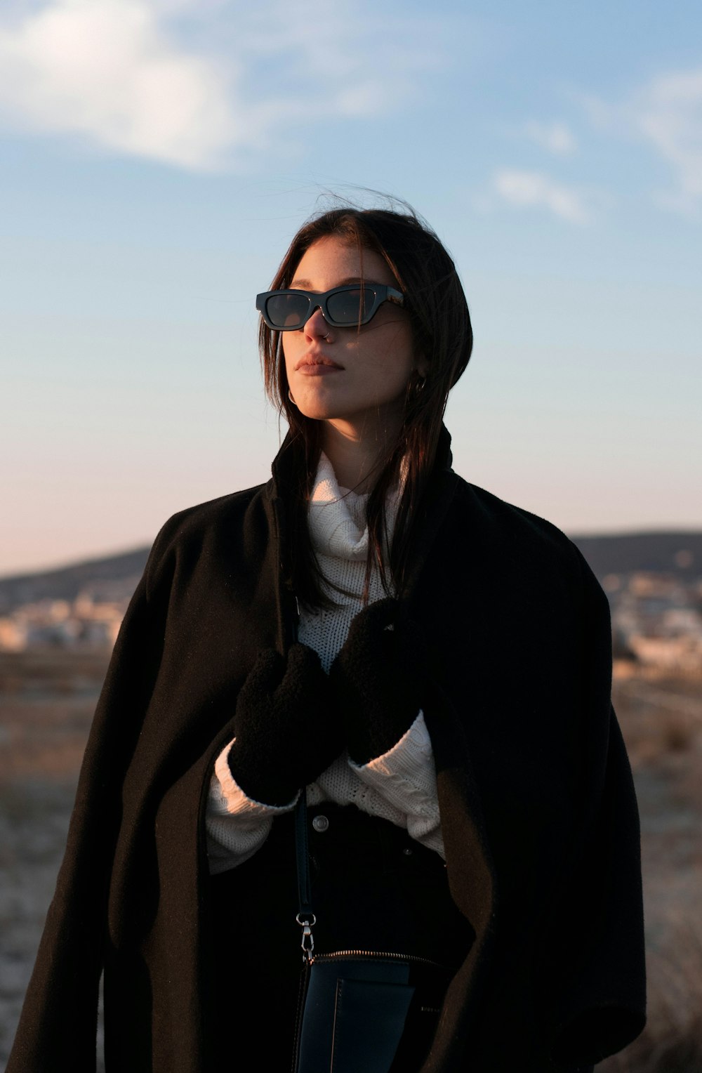 woman in black coat and white shirt wearing black sunglasses