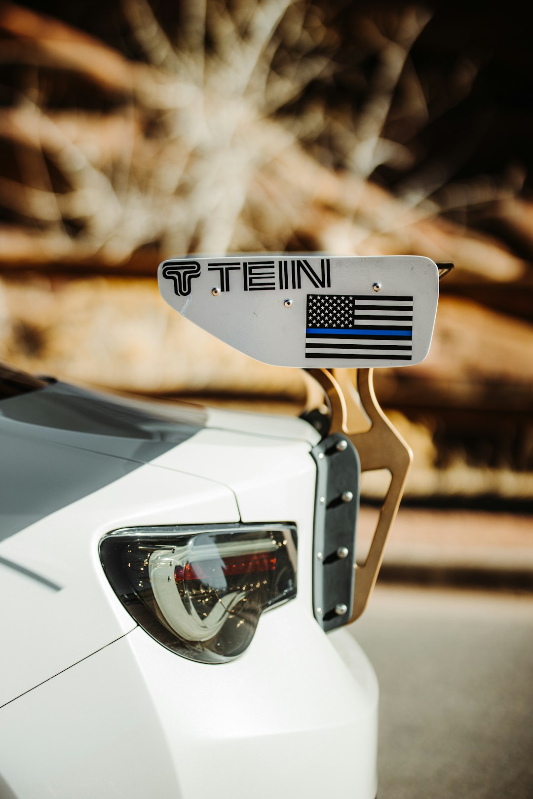 white and black car in close up photography during daytime