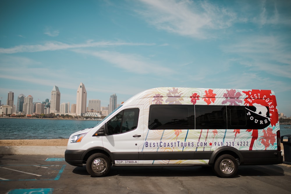 white and red van on the beach during daytime