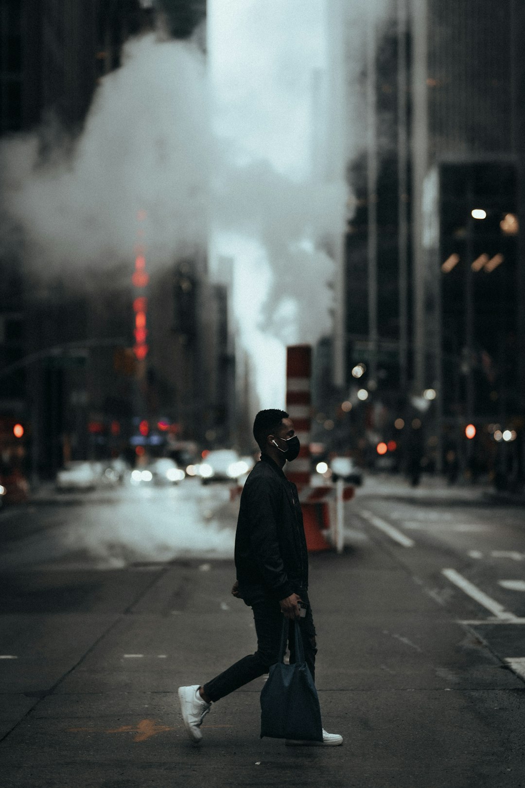 man in black coat standing on road during daytime