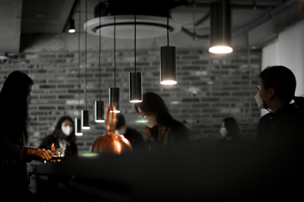 people sitting on chair in front of table with lighted candles