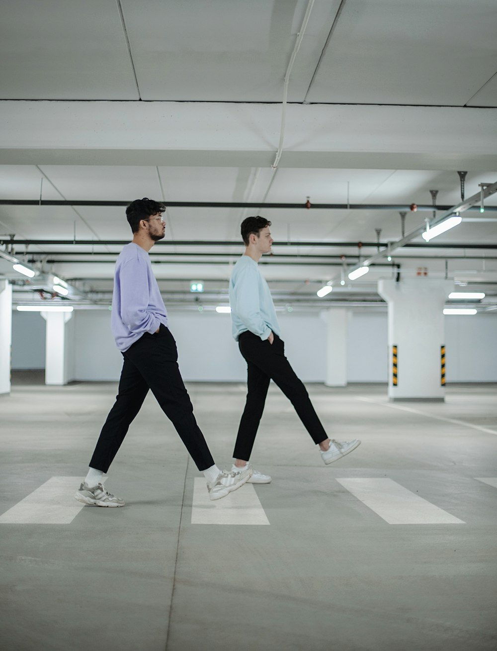 man in white shirt and black pants standing beside woman in white shirt