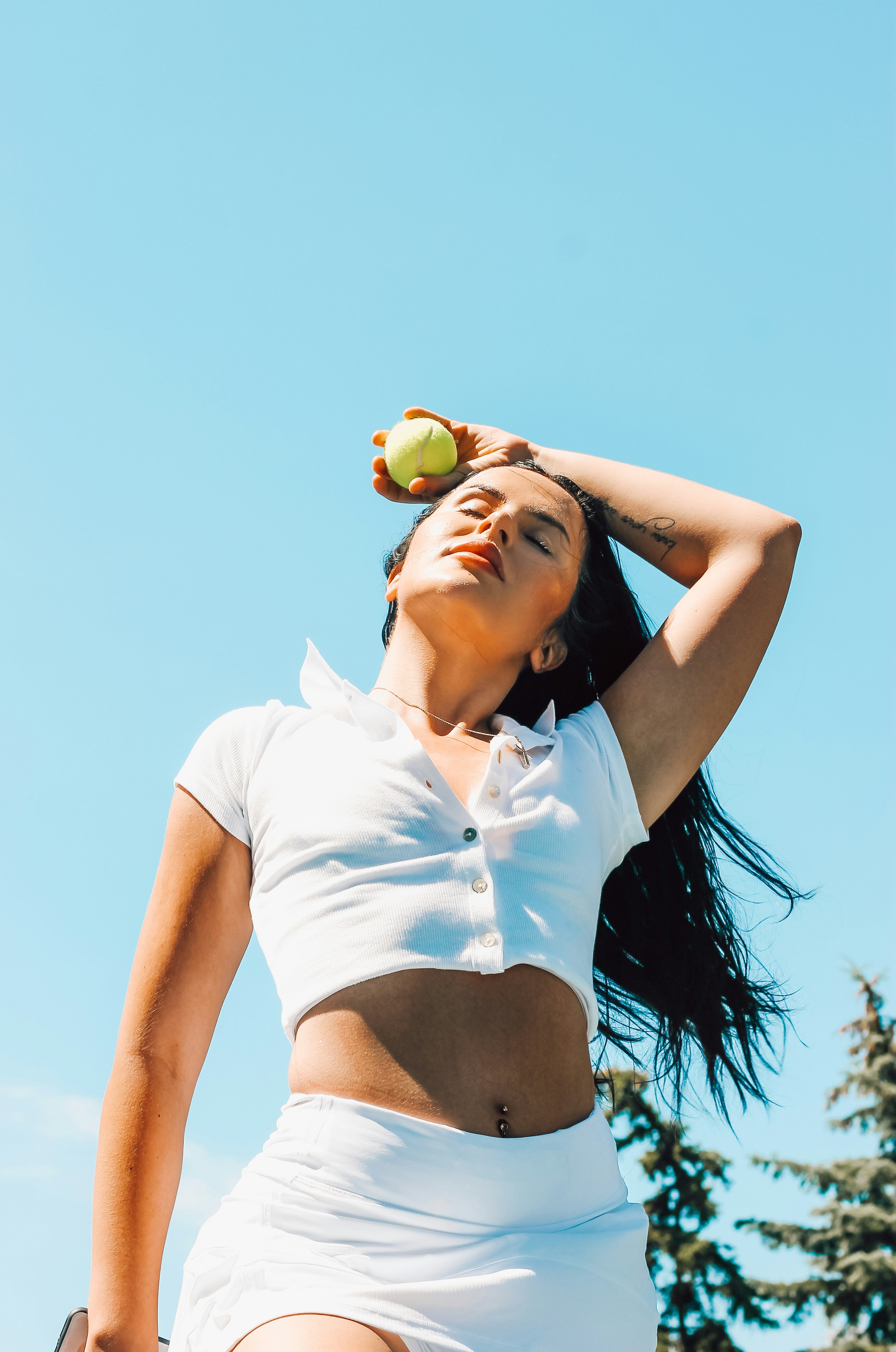 woman in white shirt and black panty holding yellow fruit