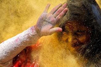 woman in red shirt with hand on face