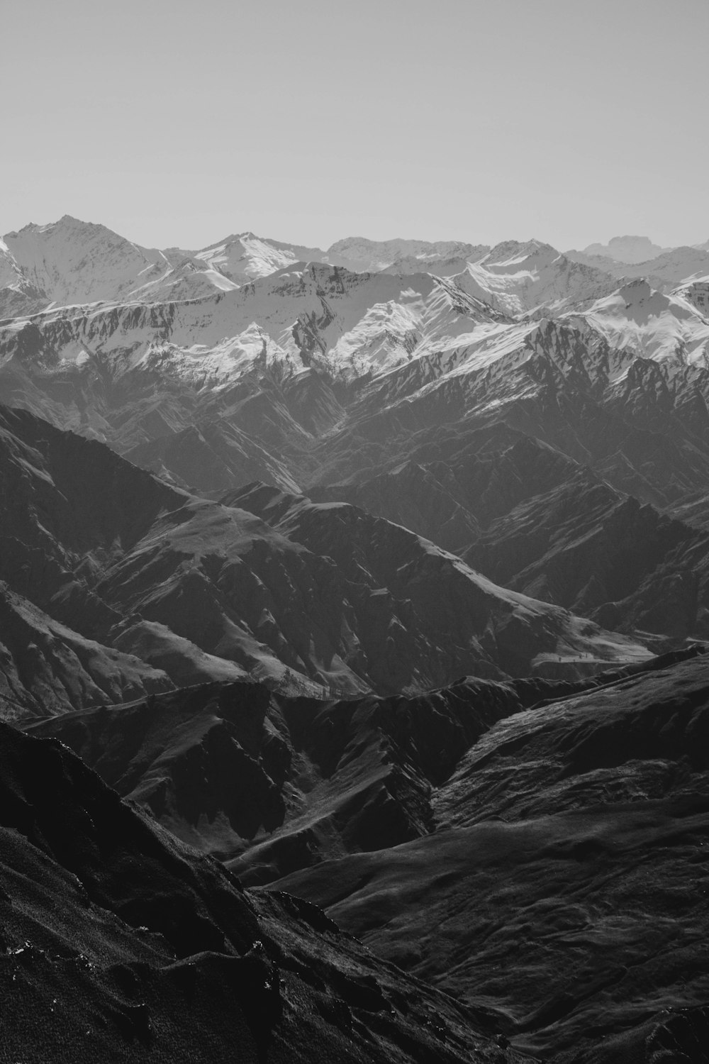 grayscale photo of snow covered mountains