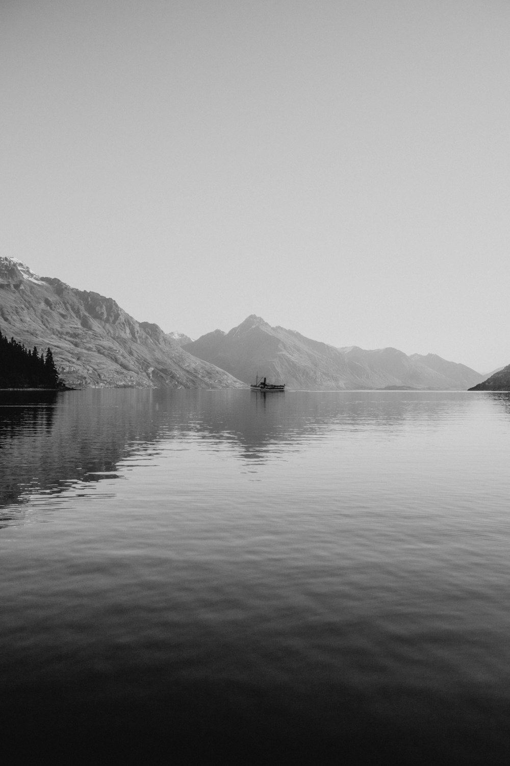 grayscale photo of lake and mountains