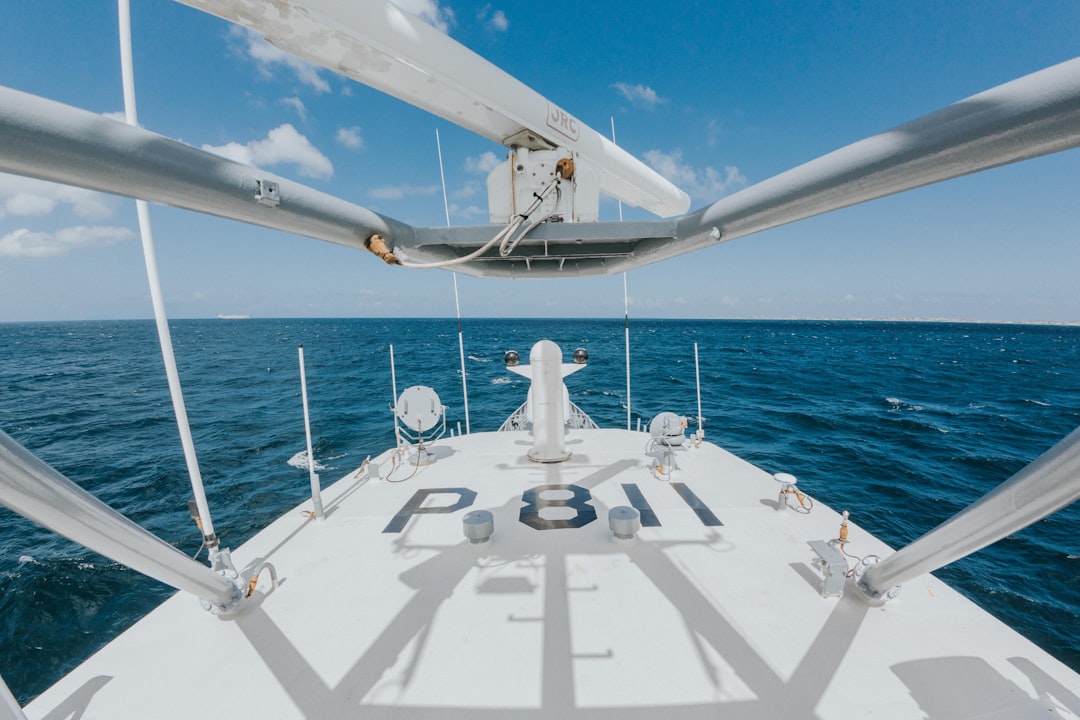 white ship on sea under blue sky during daytime