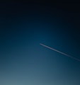 white and black plane on blue sky