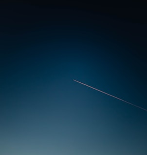white and black plane on blue sky