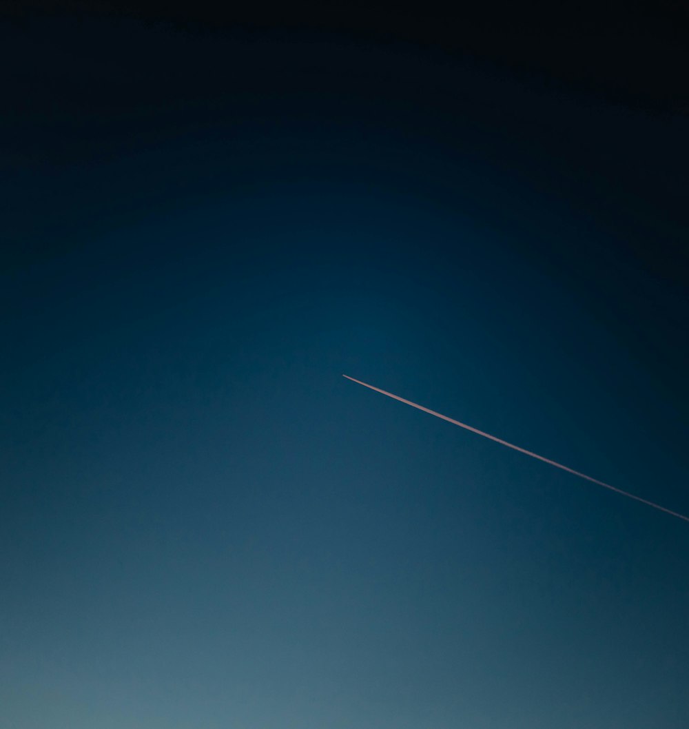 white and black plane on blue sky