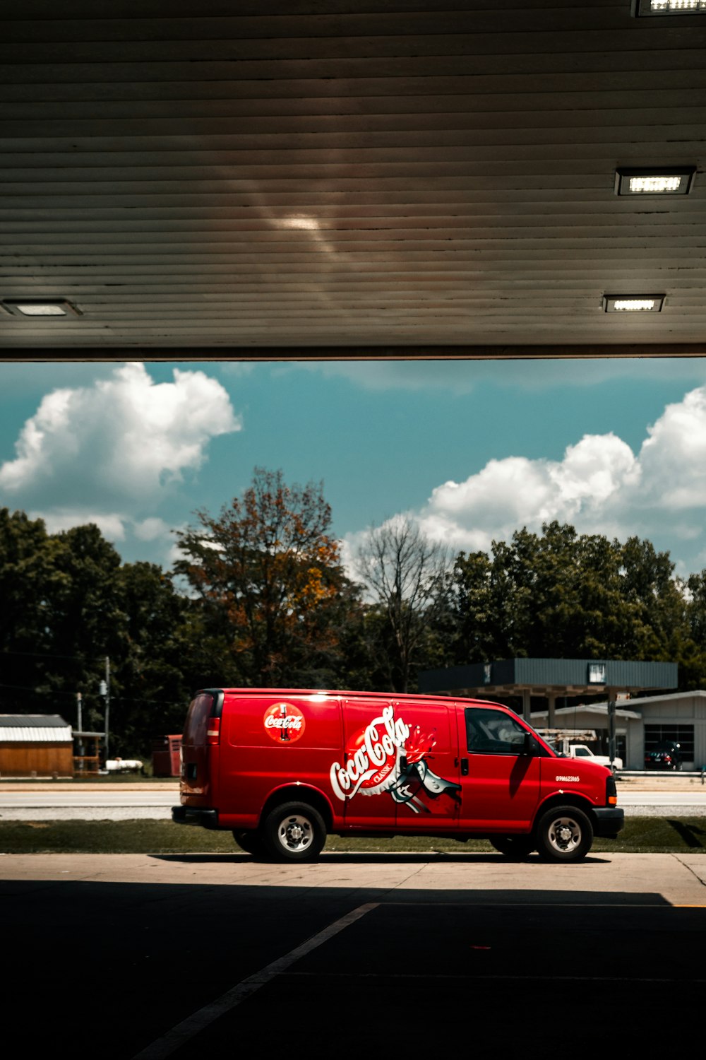 red van parked on parking lot during daytime