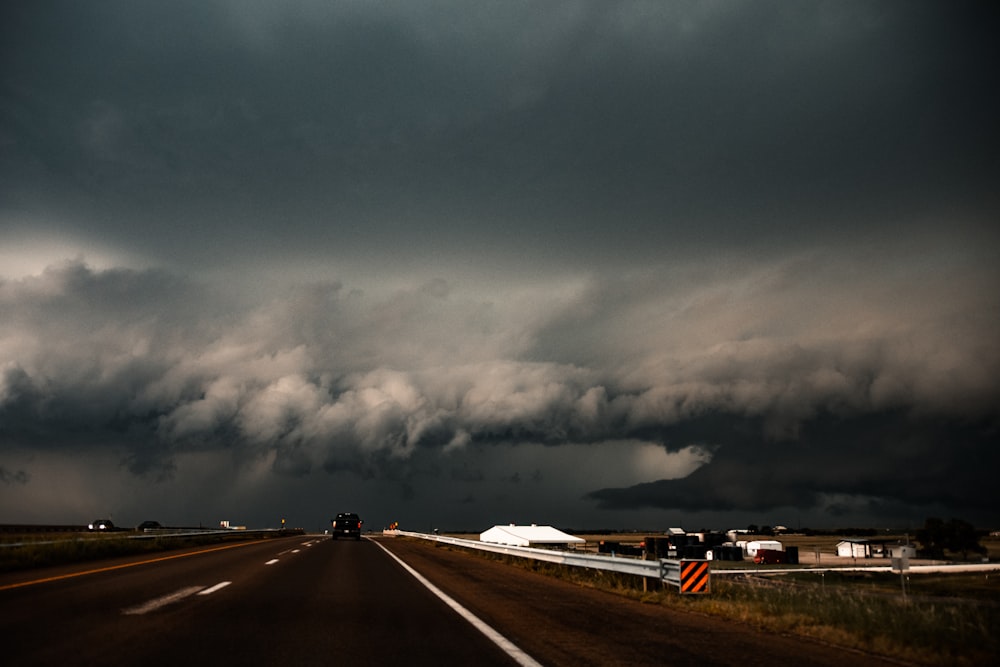 gray asphalt road under gray clouds