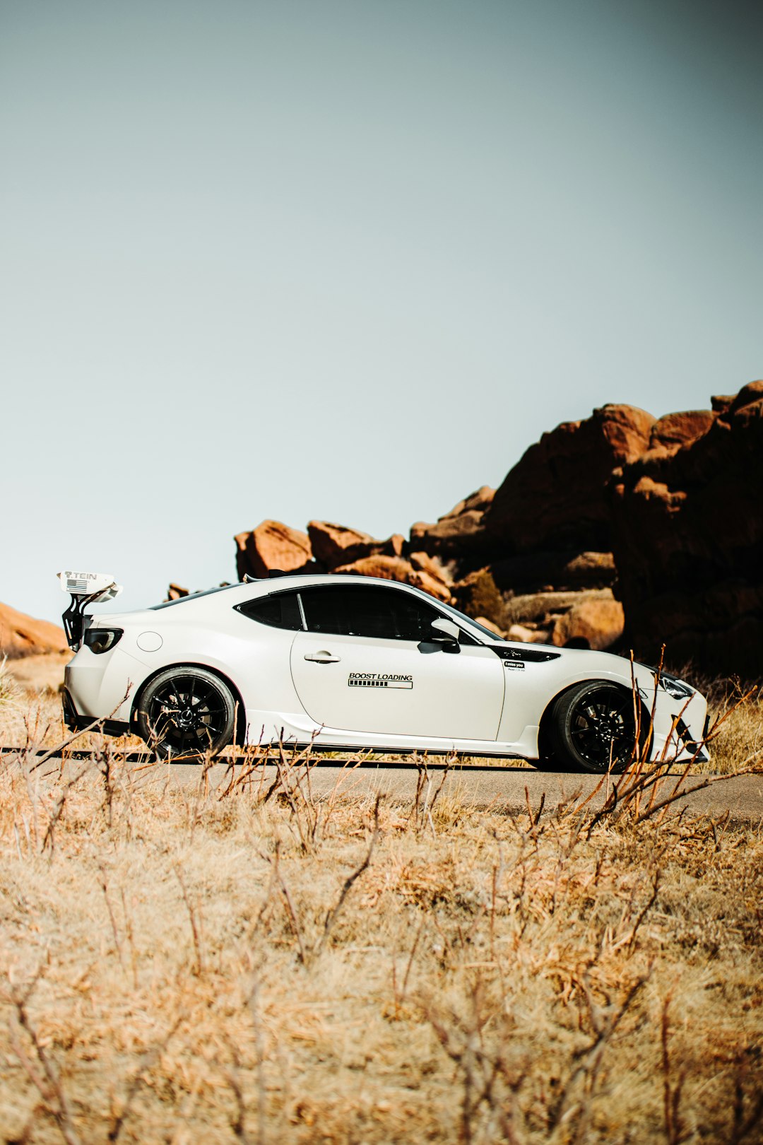 white porsche 911 on brown field during daytime