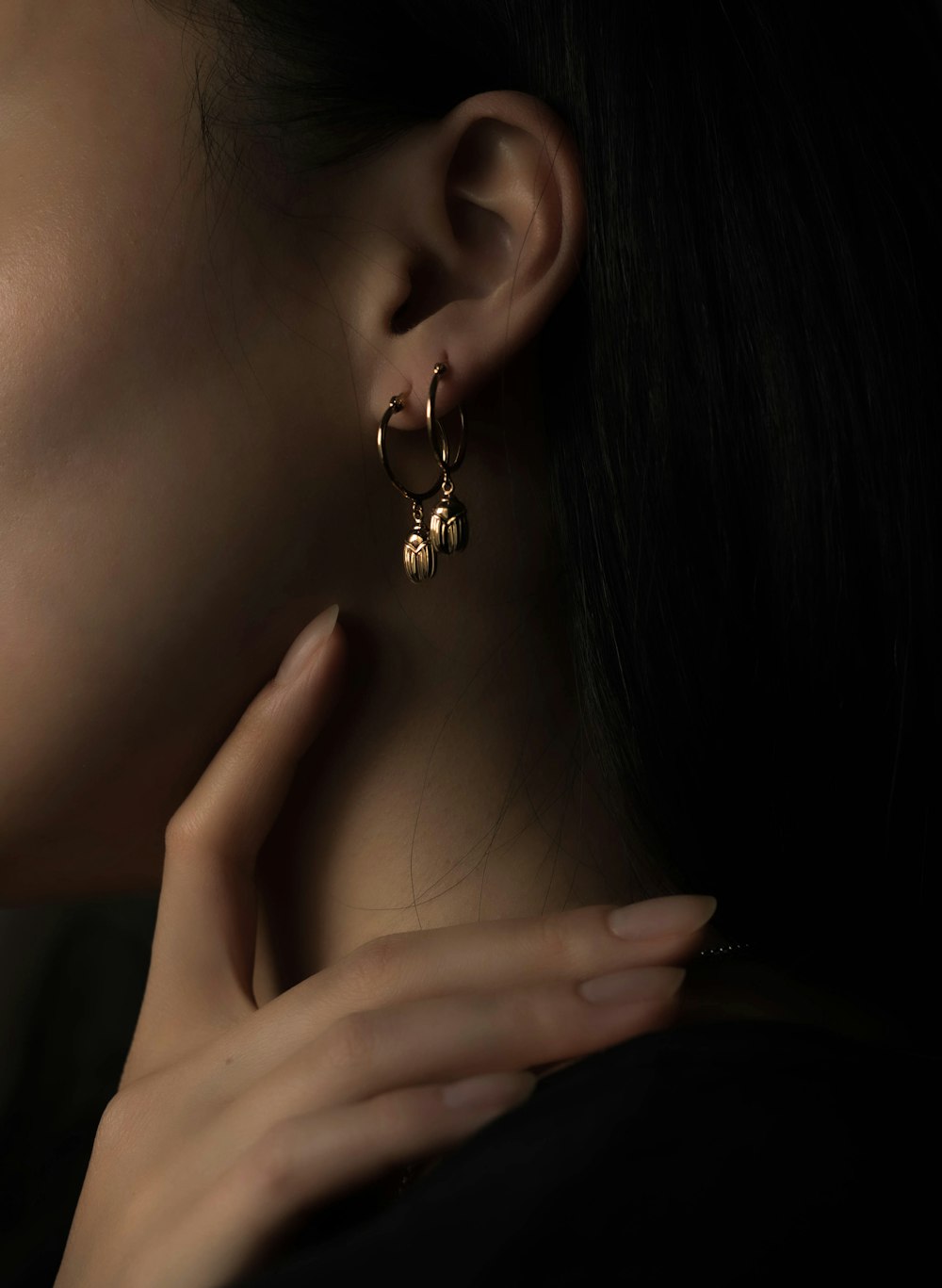 woman wearing silver heart stud earring