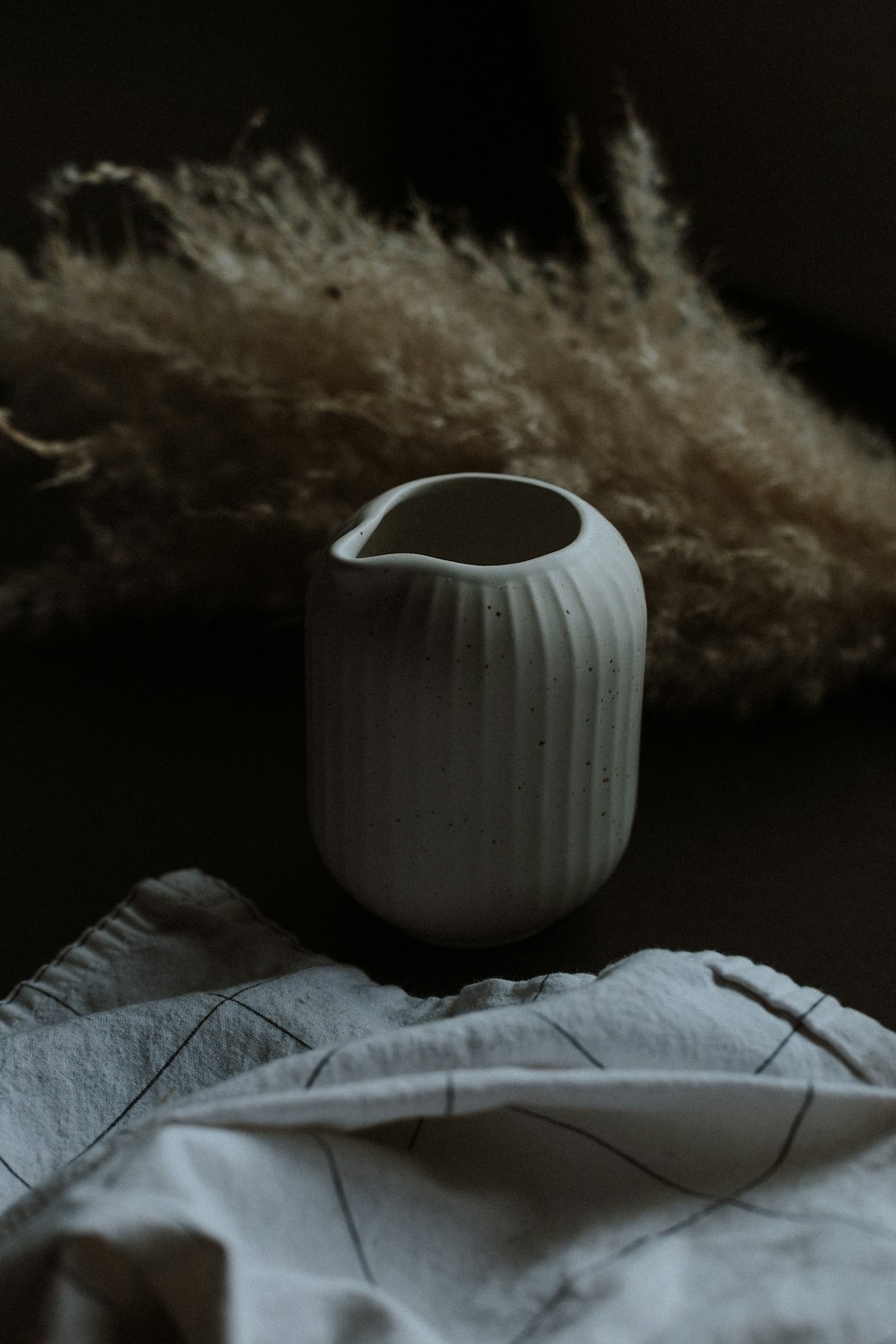 white ceramic vase on black table