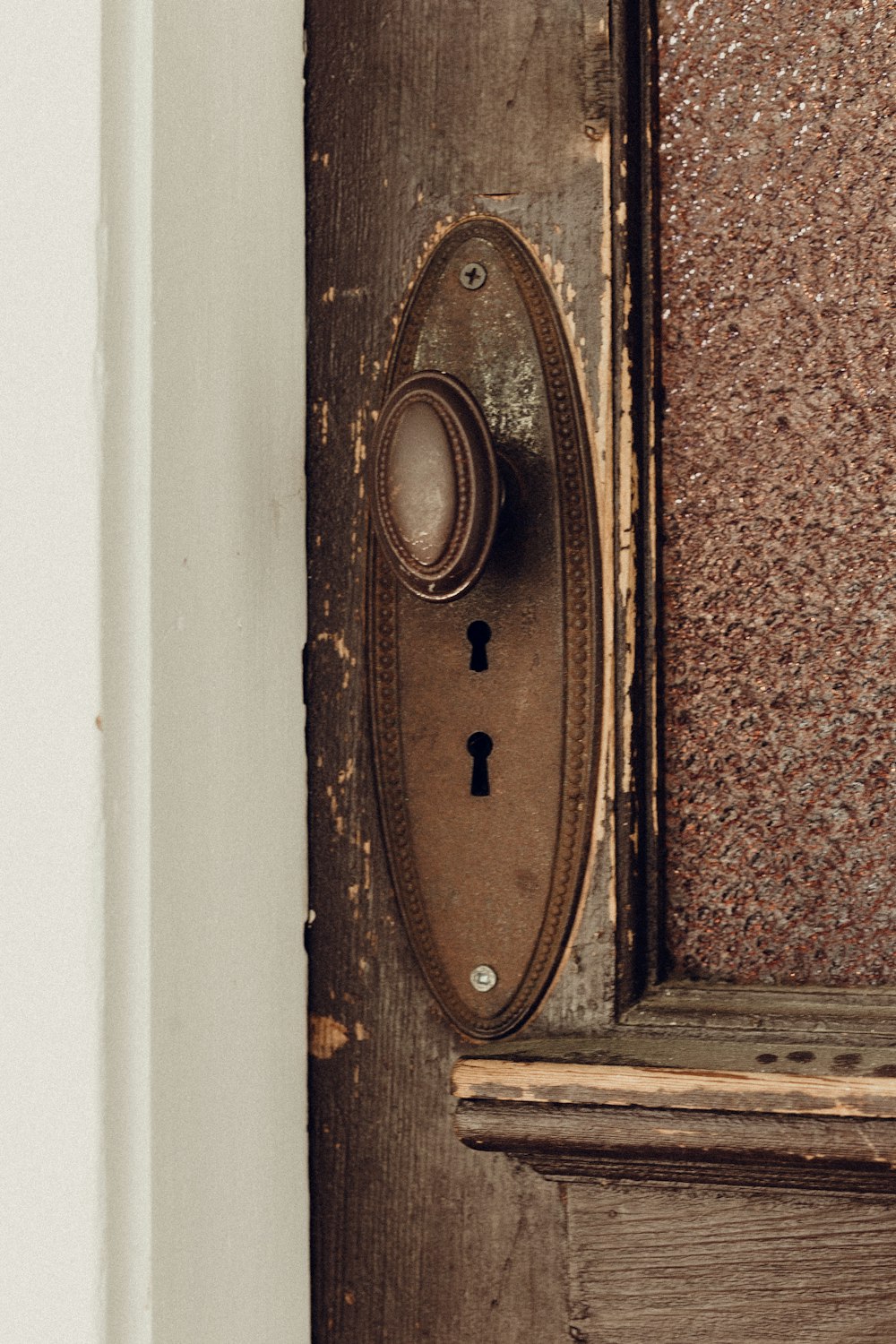 brown wooden door with brass door knob