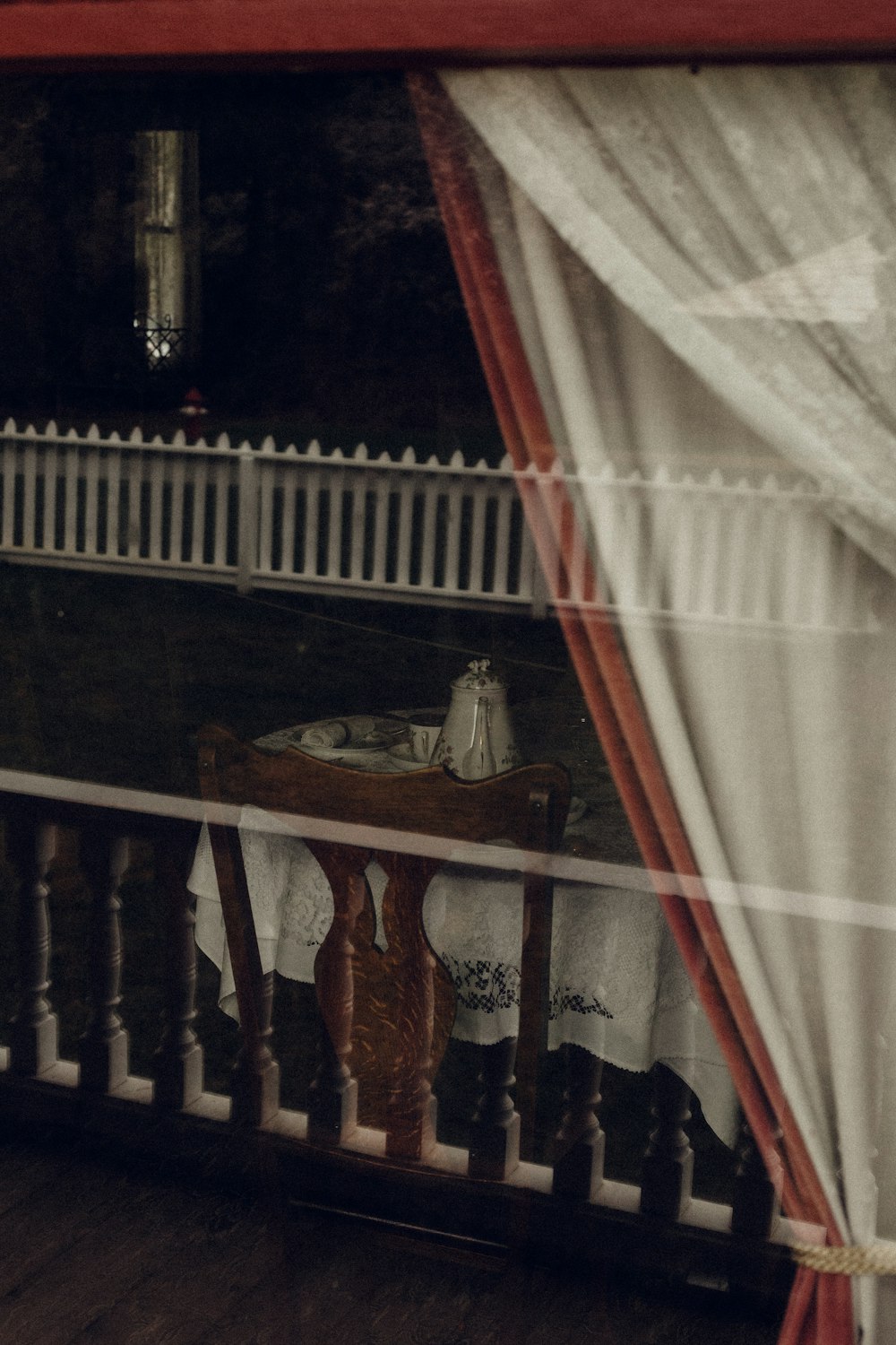 brown wooden table near white curtain