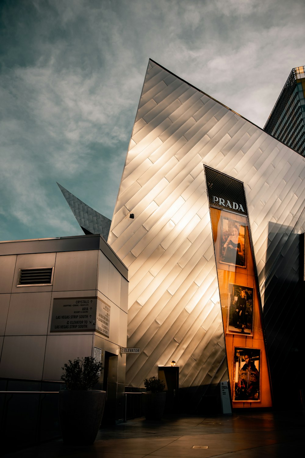 low angle photography of brown concrete building under gray clouds during daytime