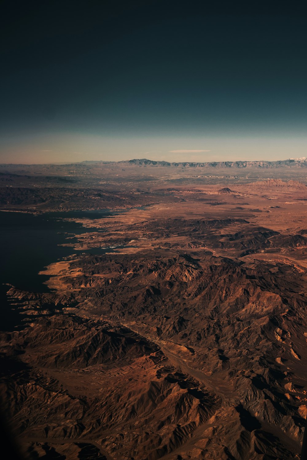 brown mountains near body of water during daytime