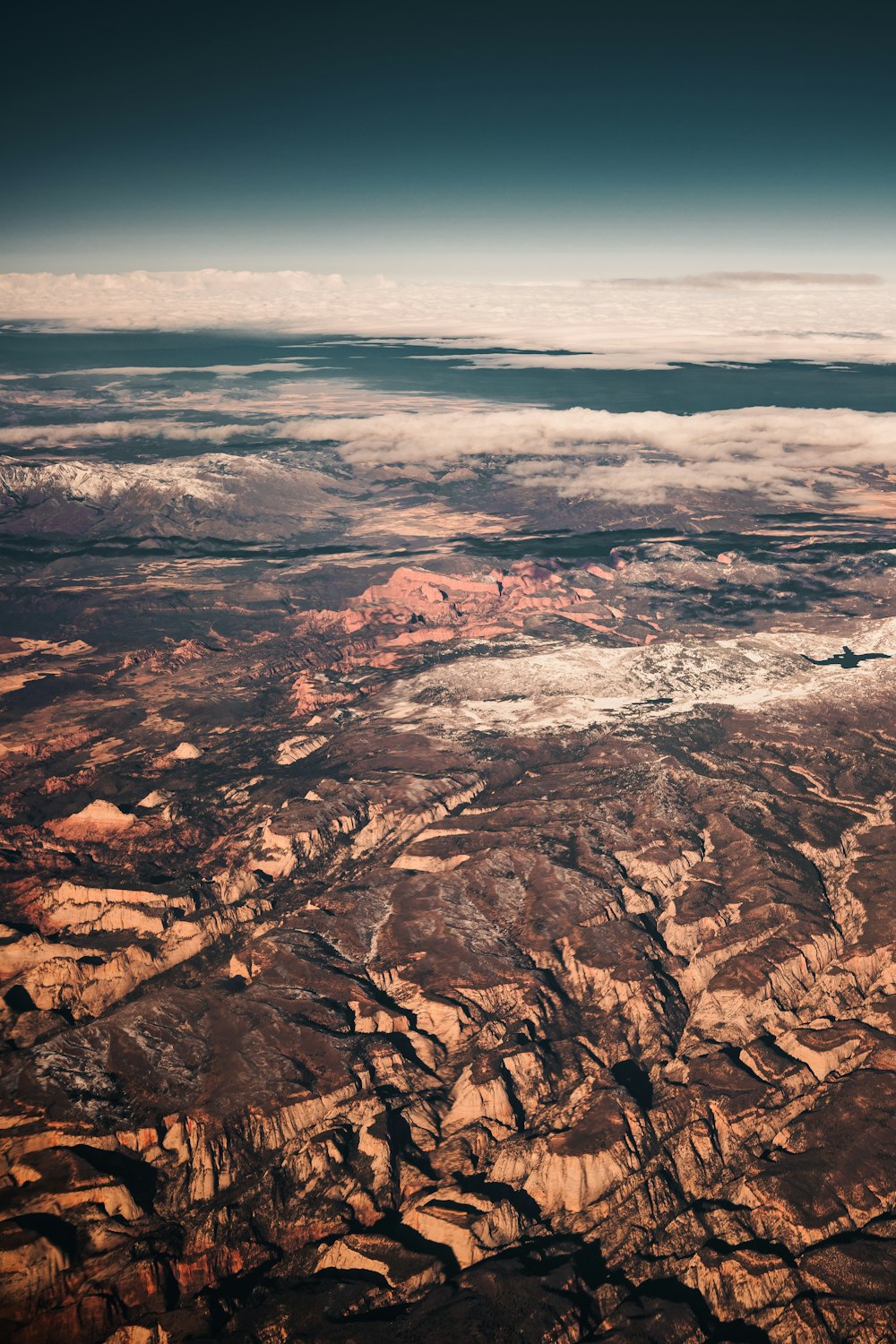 brown rocky mountain under white clouds during daytime