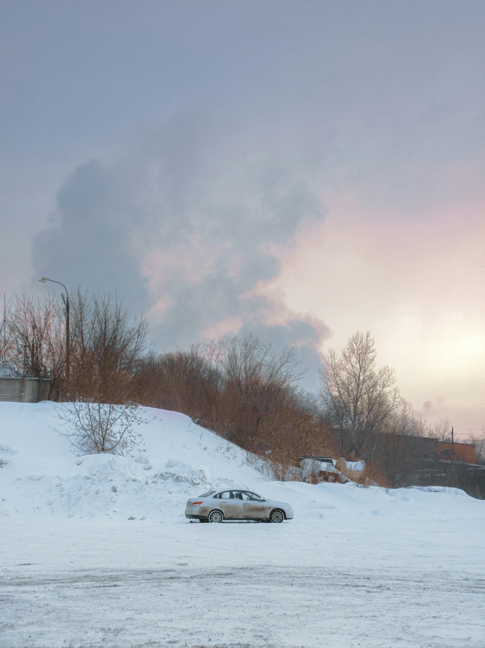 white sedan on snow covered road during daytime