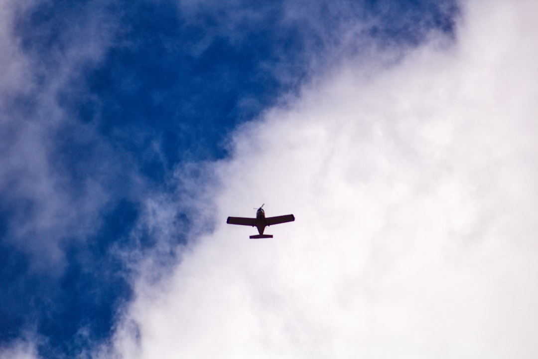 airplane in mid air under blue sky during daytime