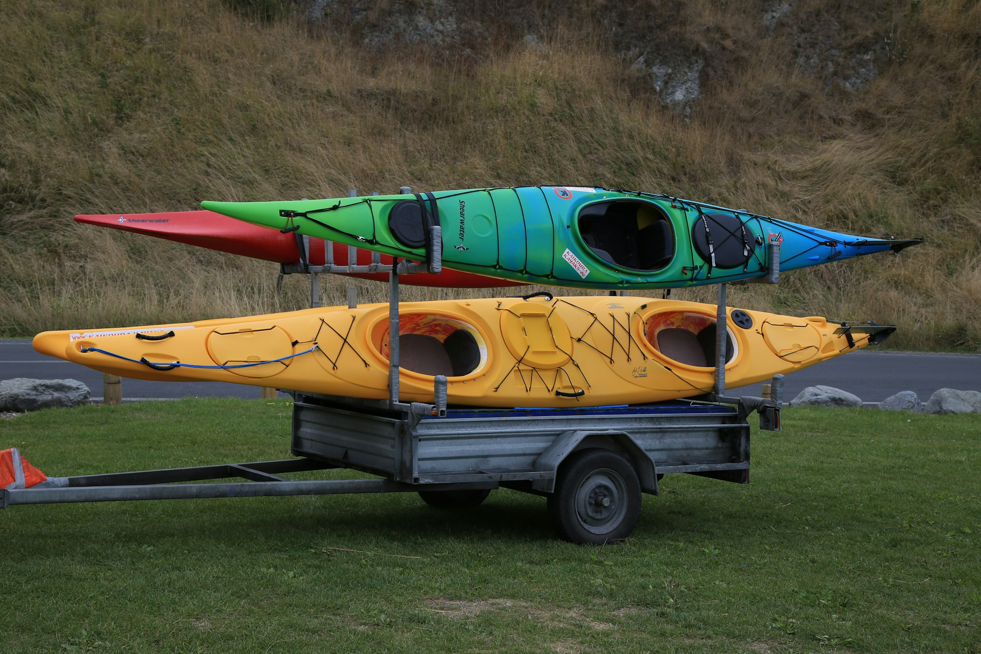 3 colorful kayaks on a trailer