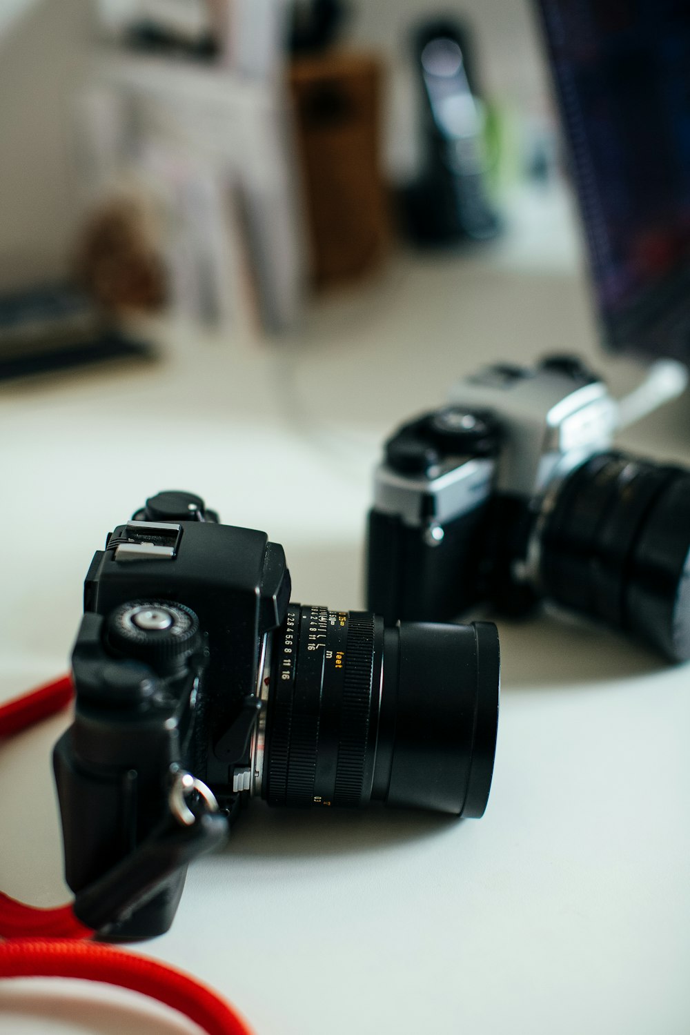 black nikon dslr camera on white table