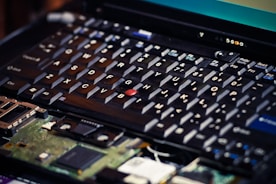 Close-up of a technician fixing a laptop keyboard