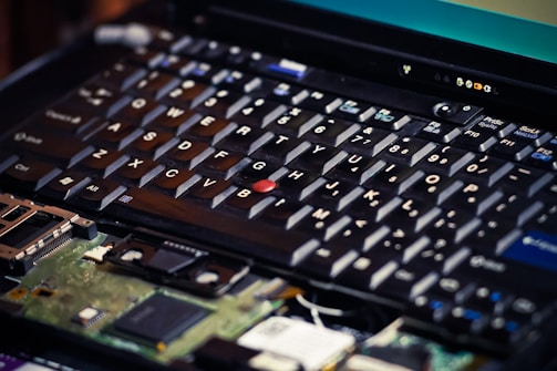 Close-up of hands replacing a laptop keyboard.