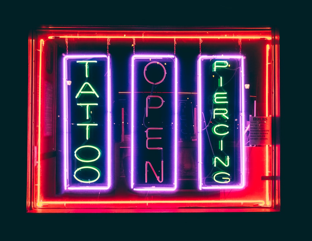a neon sign with the words tattoo on it