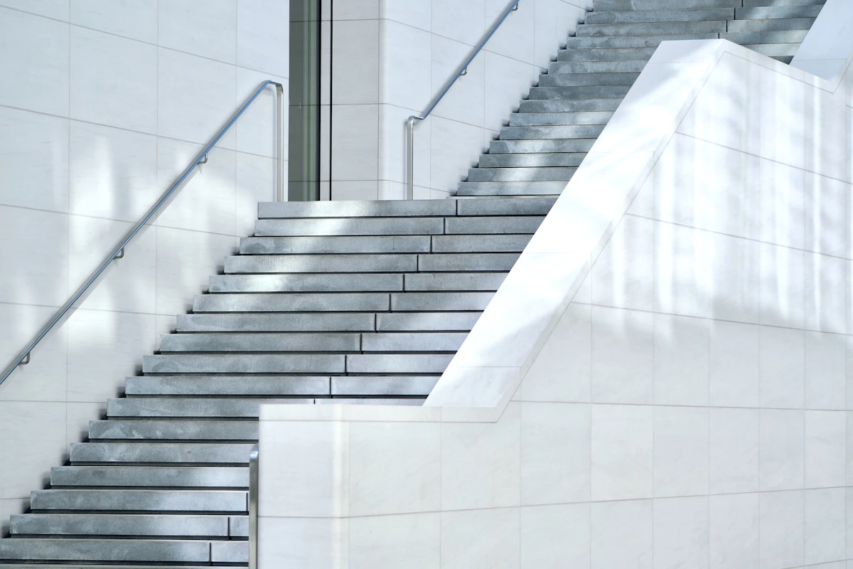 Concrete staircase with metal handrails