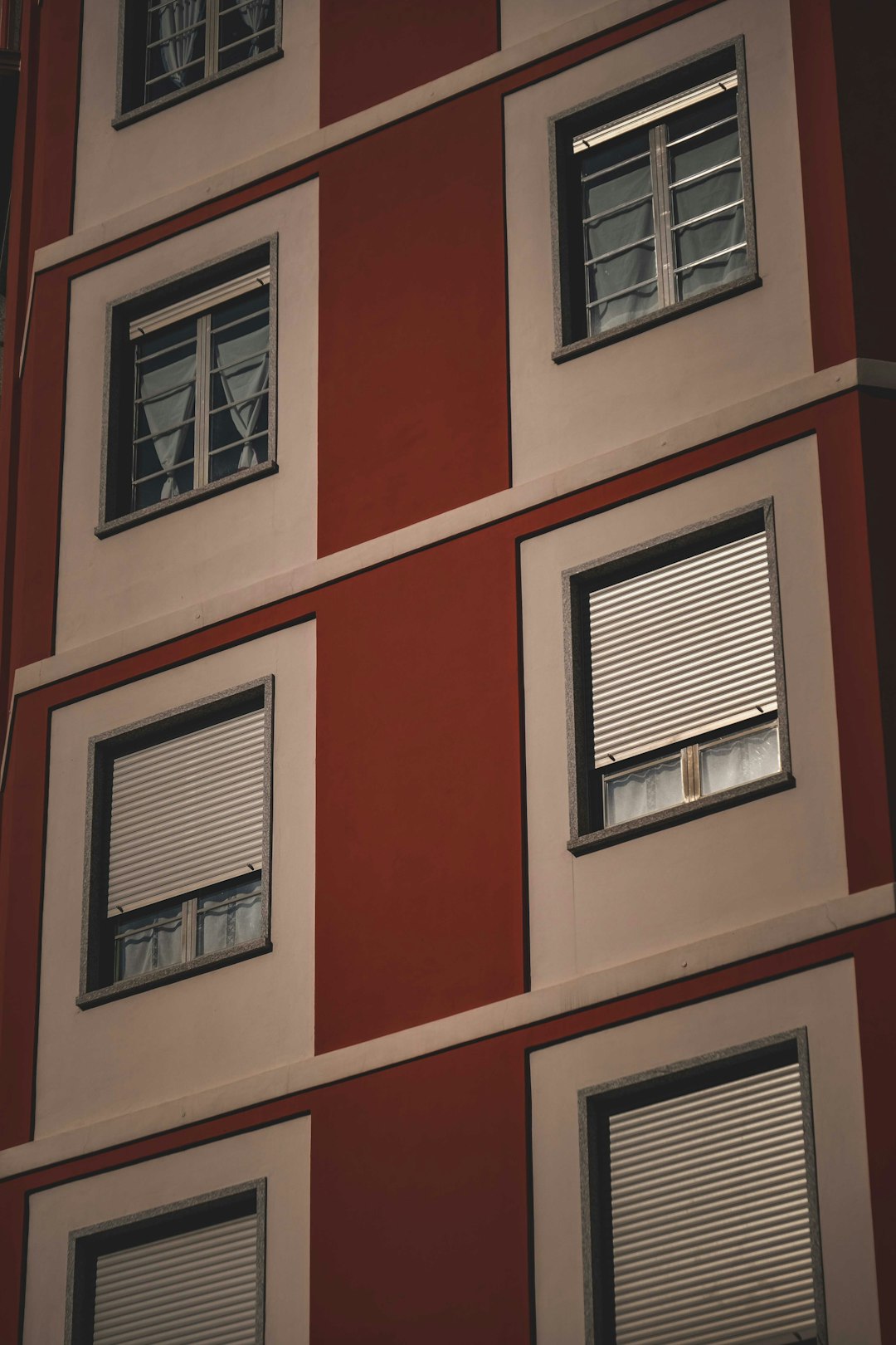 red concrete building with white window blinds