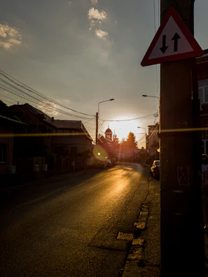 A quiet street illuminated by the golden light of sunset.