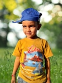 A child happily wearing a colorful, high-quality cap outdoors.