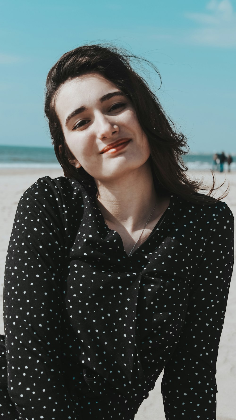 woman in black and white polka dot long sleeve shirt