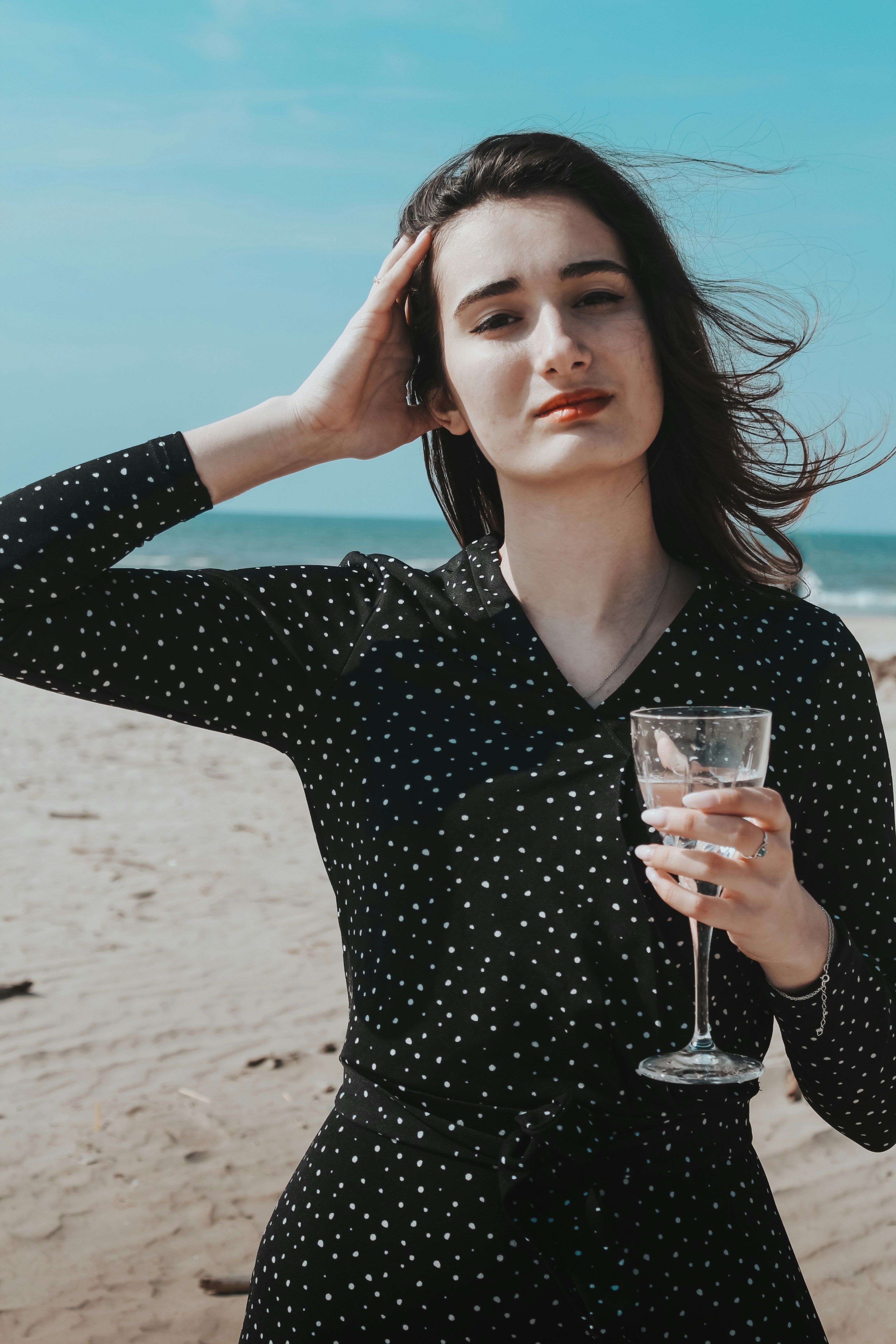 Young attractive beautiful woman drinking water on beach. Feeling happy comfort at beach