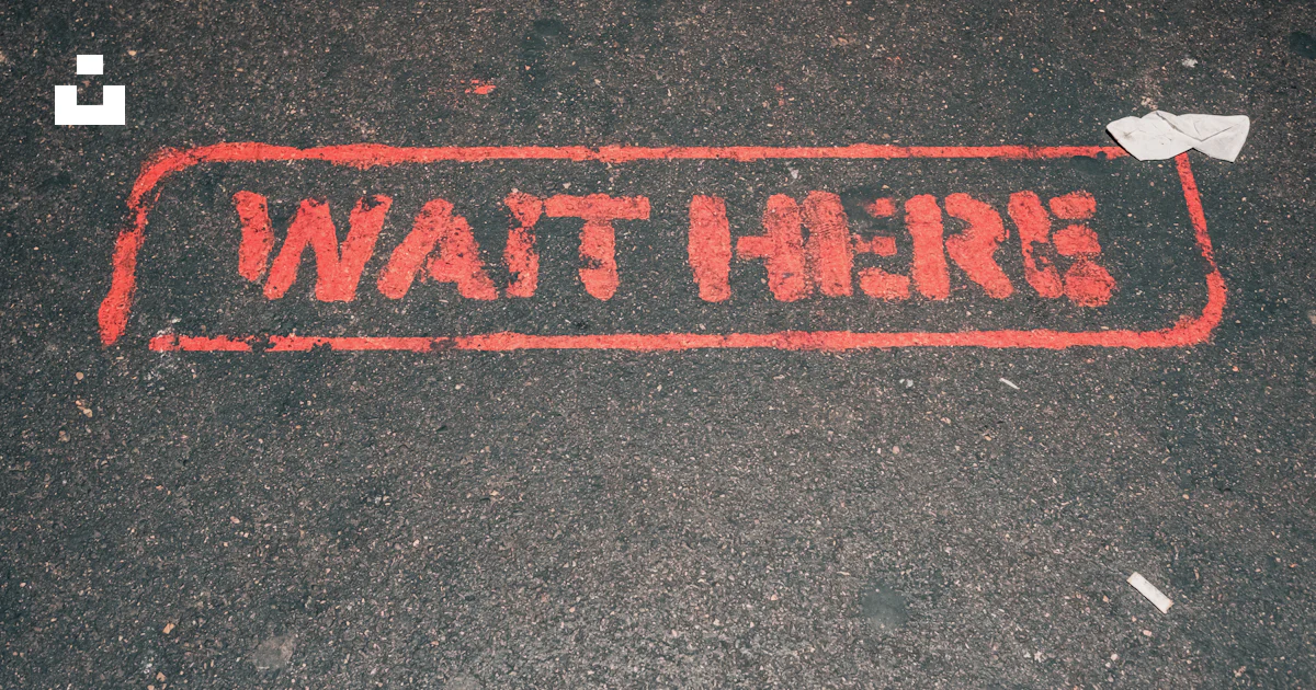 A red street sign that reads wait here photo – Free Waiting Image on ...