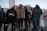 A diverse group of people showcasing trendy outfits in an urban setting.