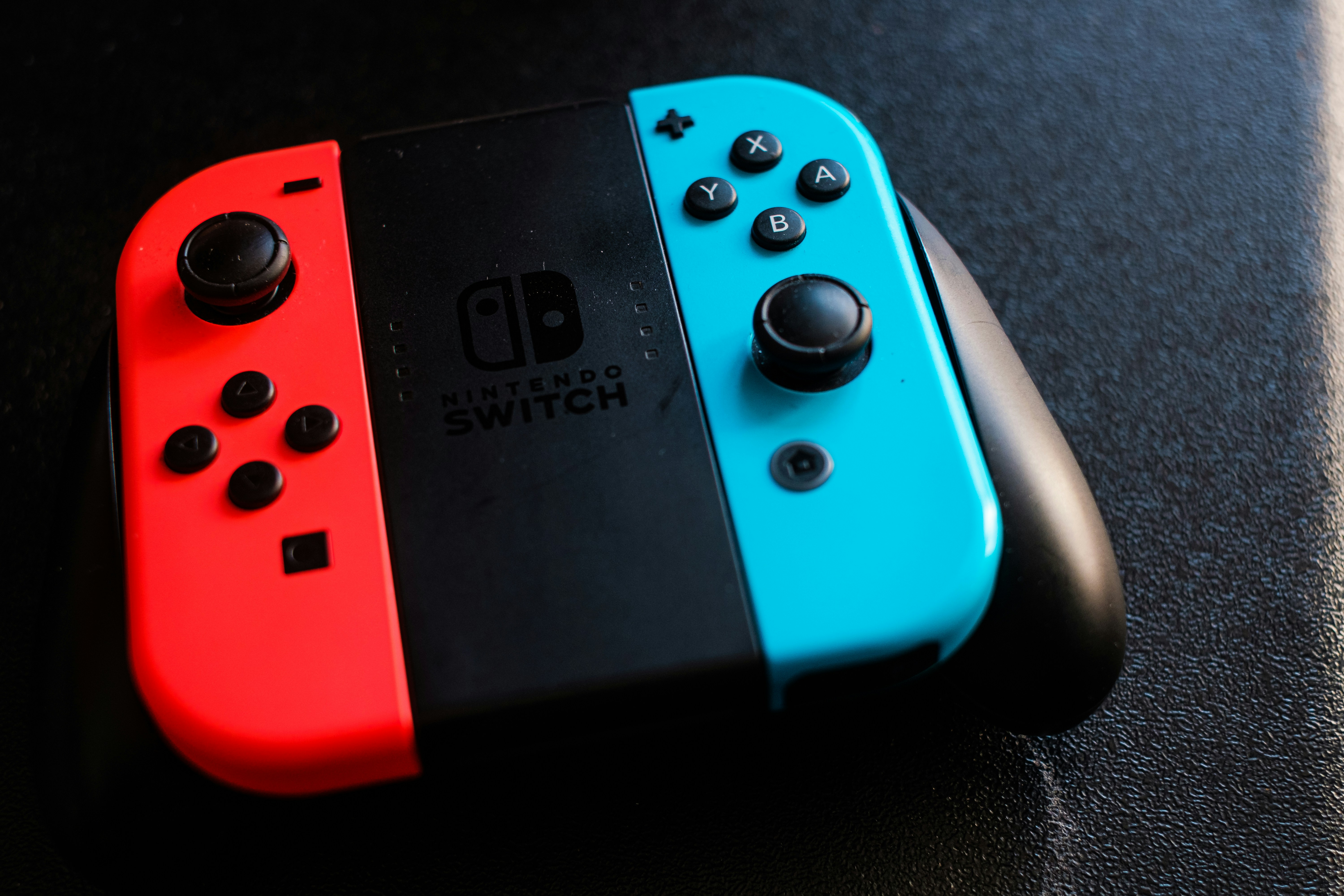 Nintendo Switch gaming console with Joy-Con controllers on a bright clean surface