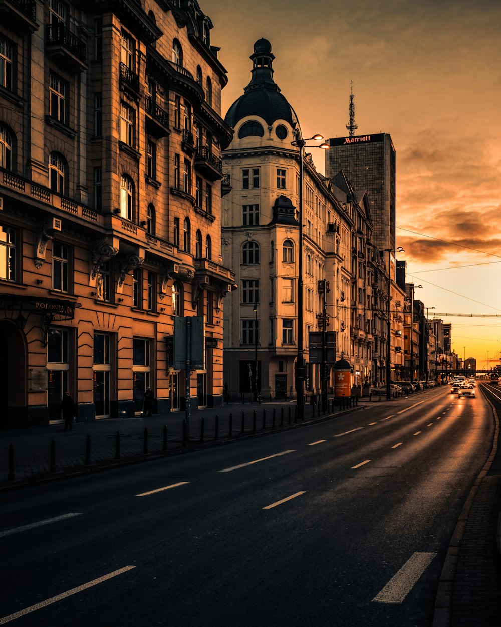 brown concrete building beside road during daytime