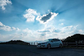 A modern car parked at a scenic overlook.