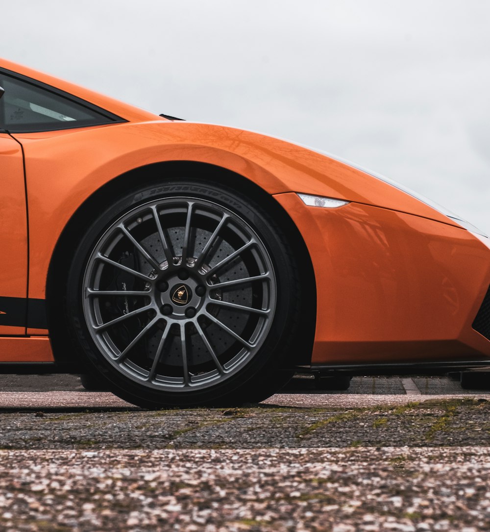 orange car on gray and black road