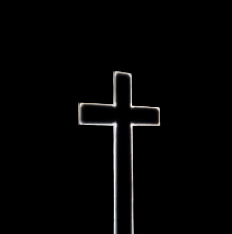 white cross with black background