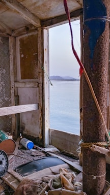A cozy sailboat cabin with a laptop open to a contact form, sunlight streaming through the porthole.