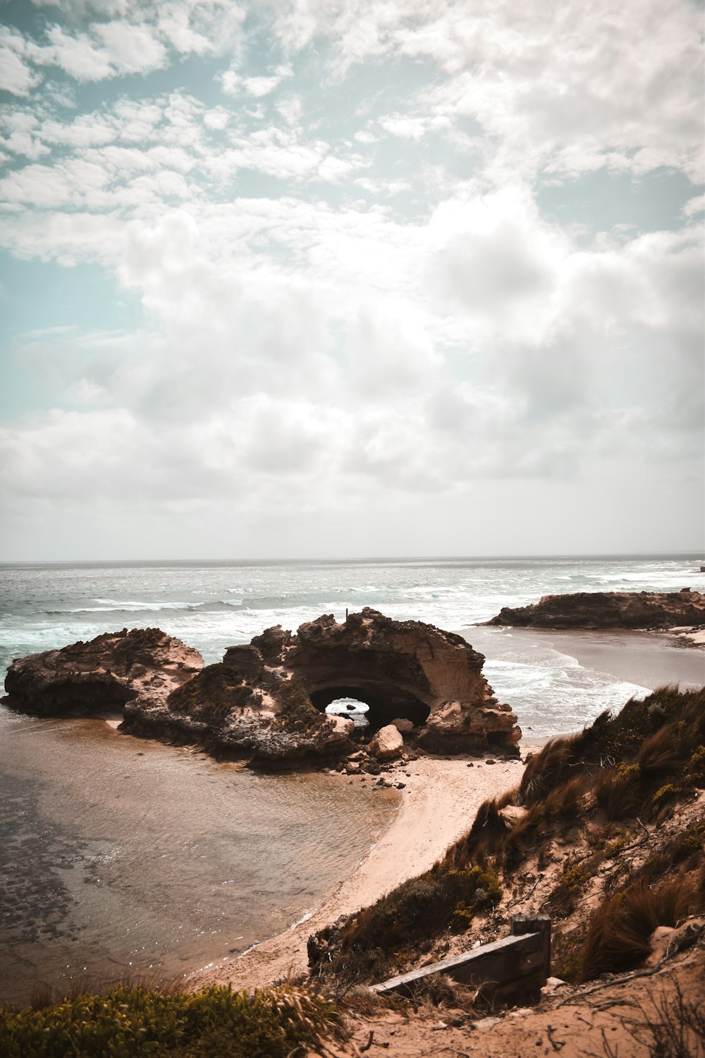 brown rock formation on beach during daytime